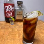 amaretto and dr pepper in glass on butcher block