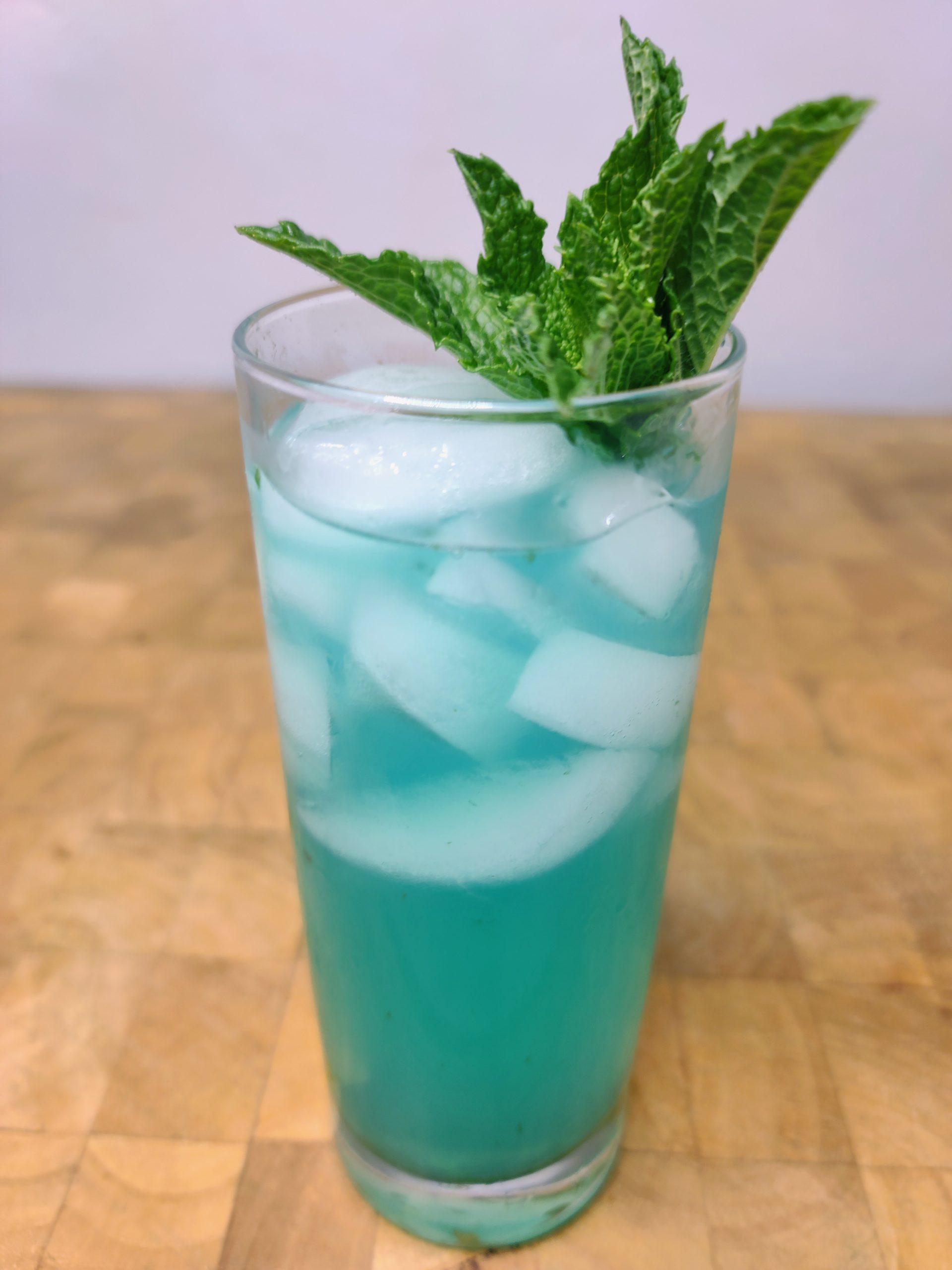 blue mojito with mint leaves on wooden table
