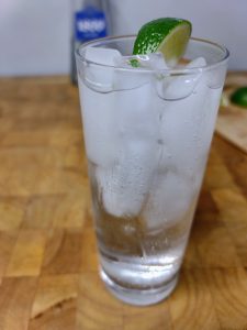 tequila and soda water with lime wedge