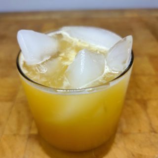 closeup of amaretto and orange juice on a wooden table