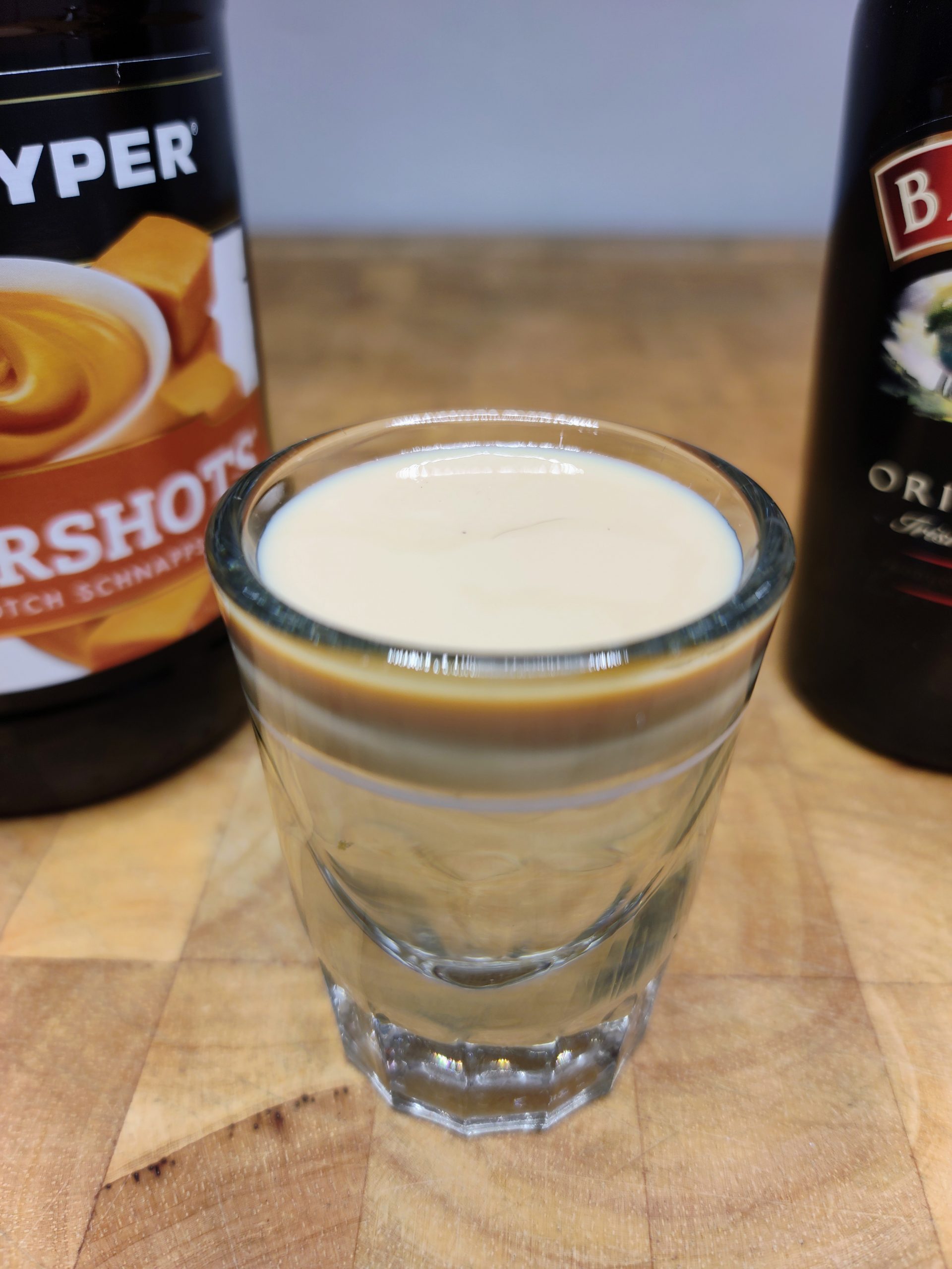 closeup of buttery nipple shot with bottles in background