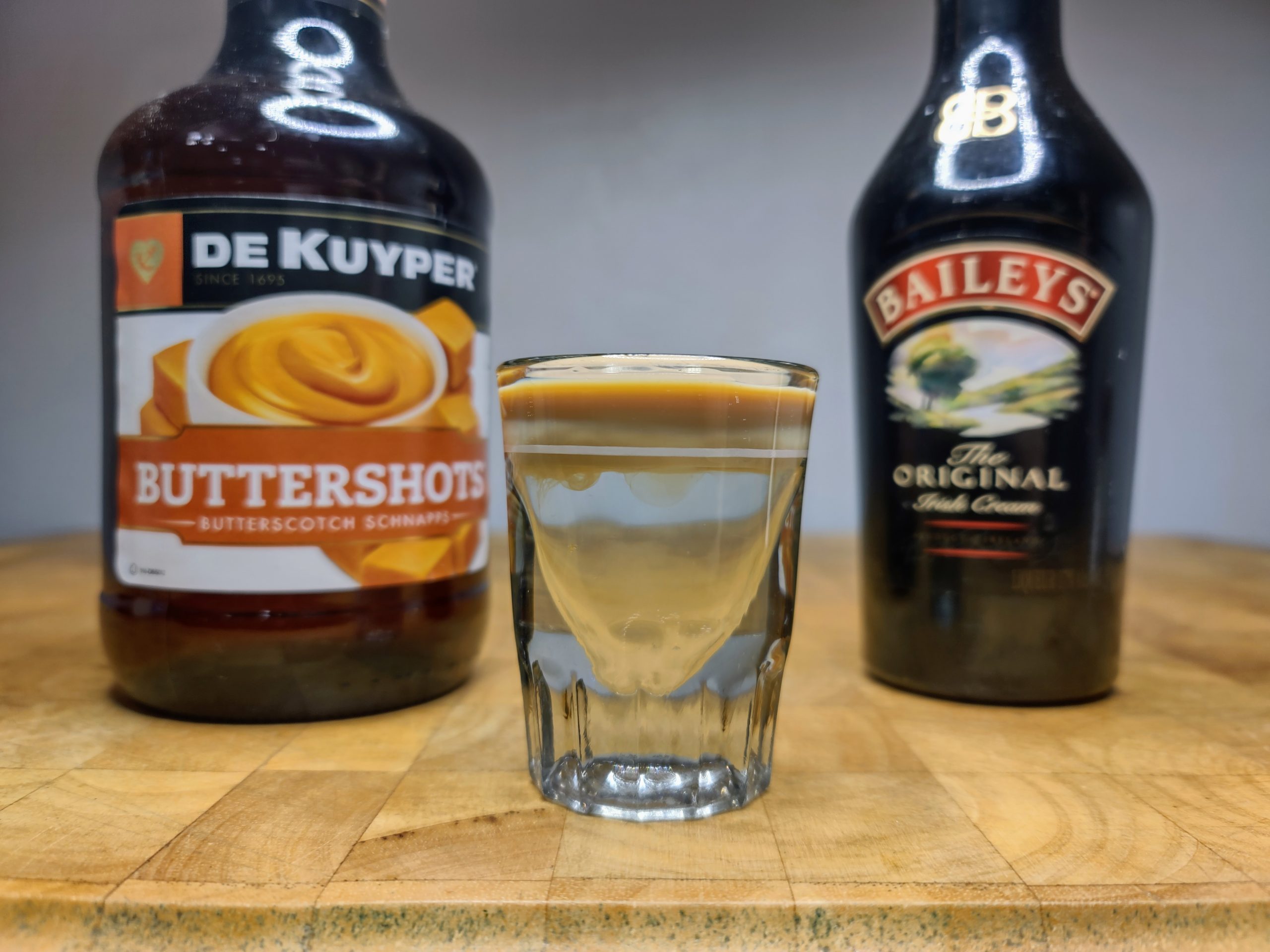 buttery nipple shot with ingredients next to it