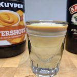 buttery nipple shot with bottles behind it