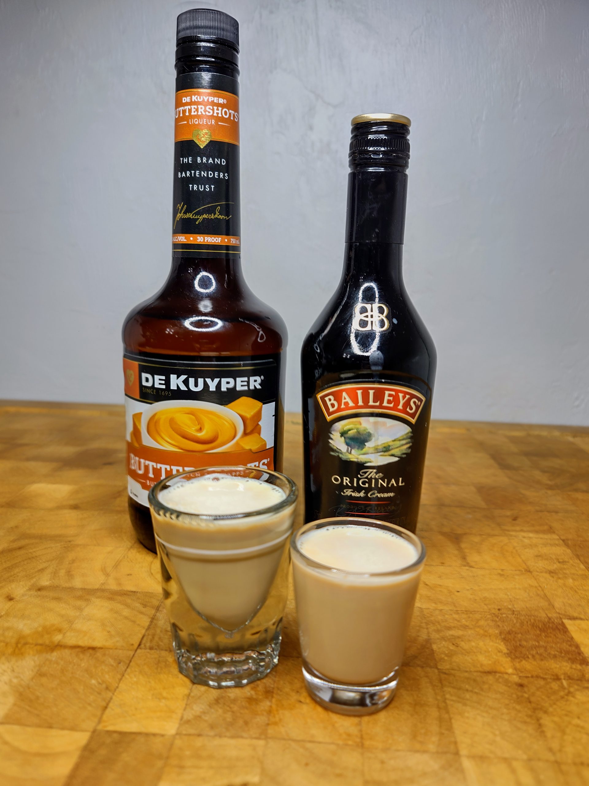 two copper camel shots with ingredients next to them