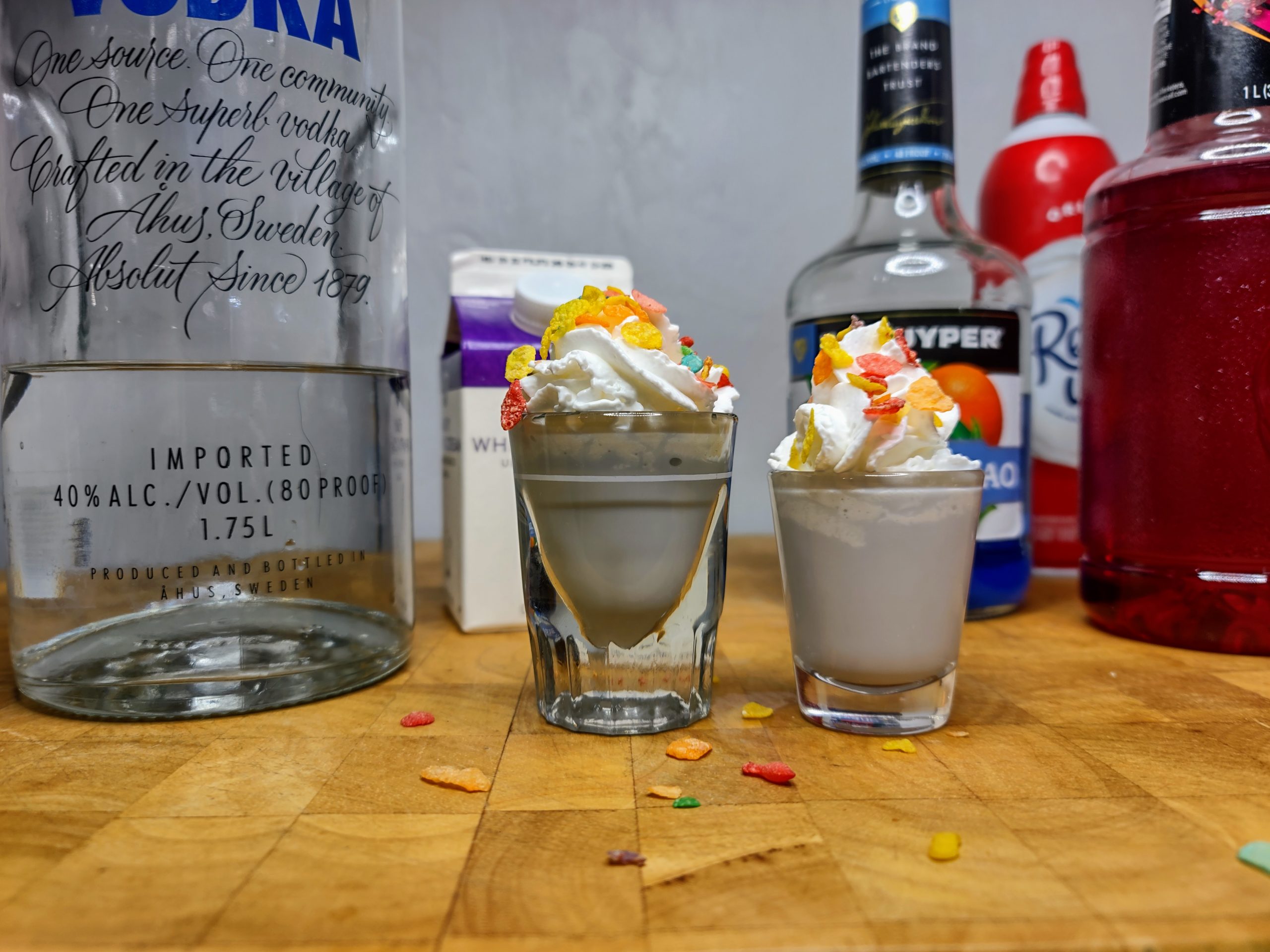 two fruity pebbles shots with all ingredients behind them