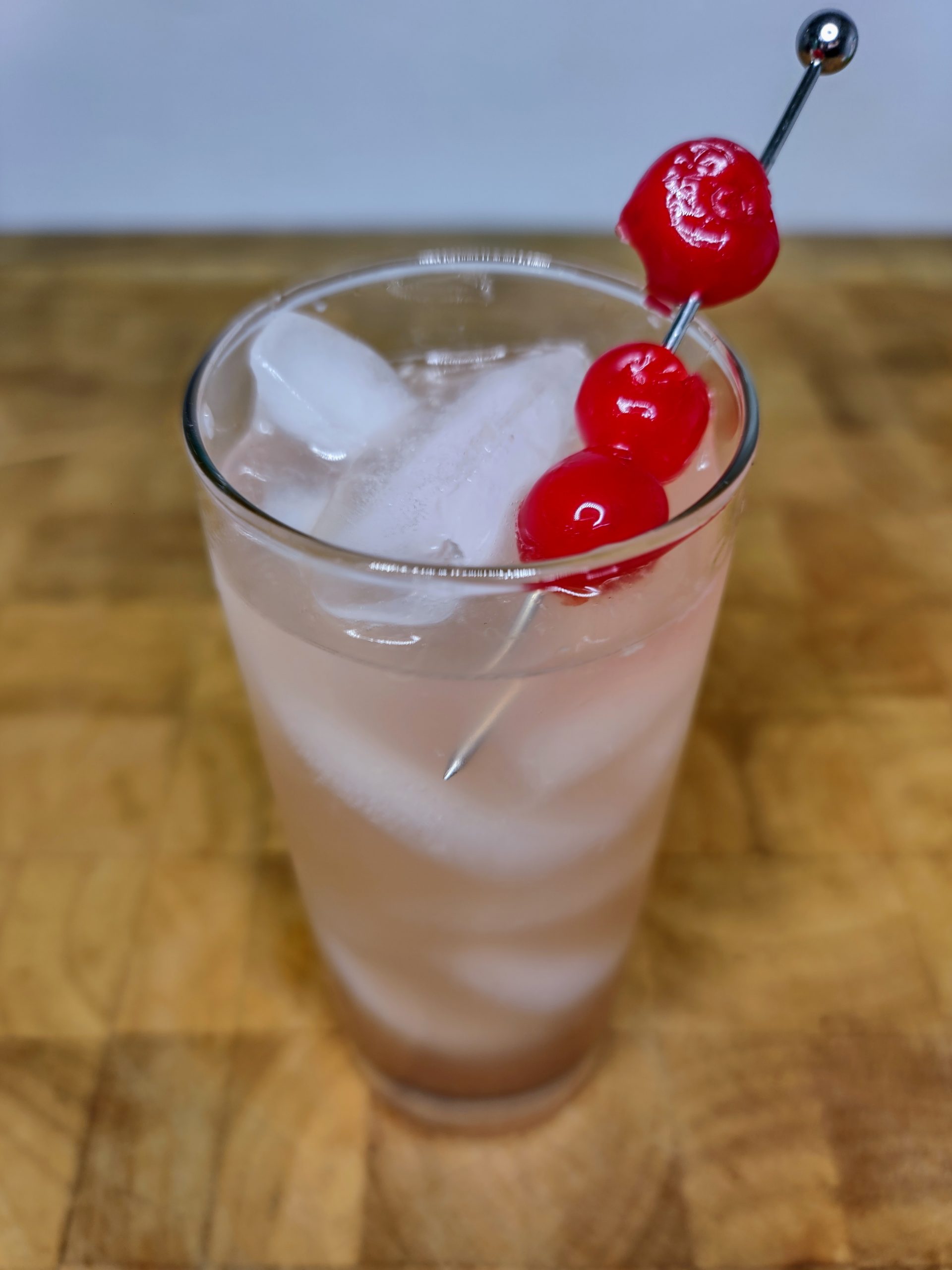 hunch punch in a glass with cherry garnish