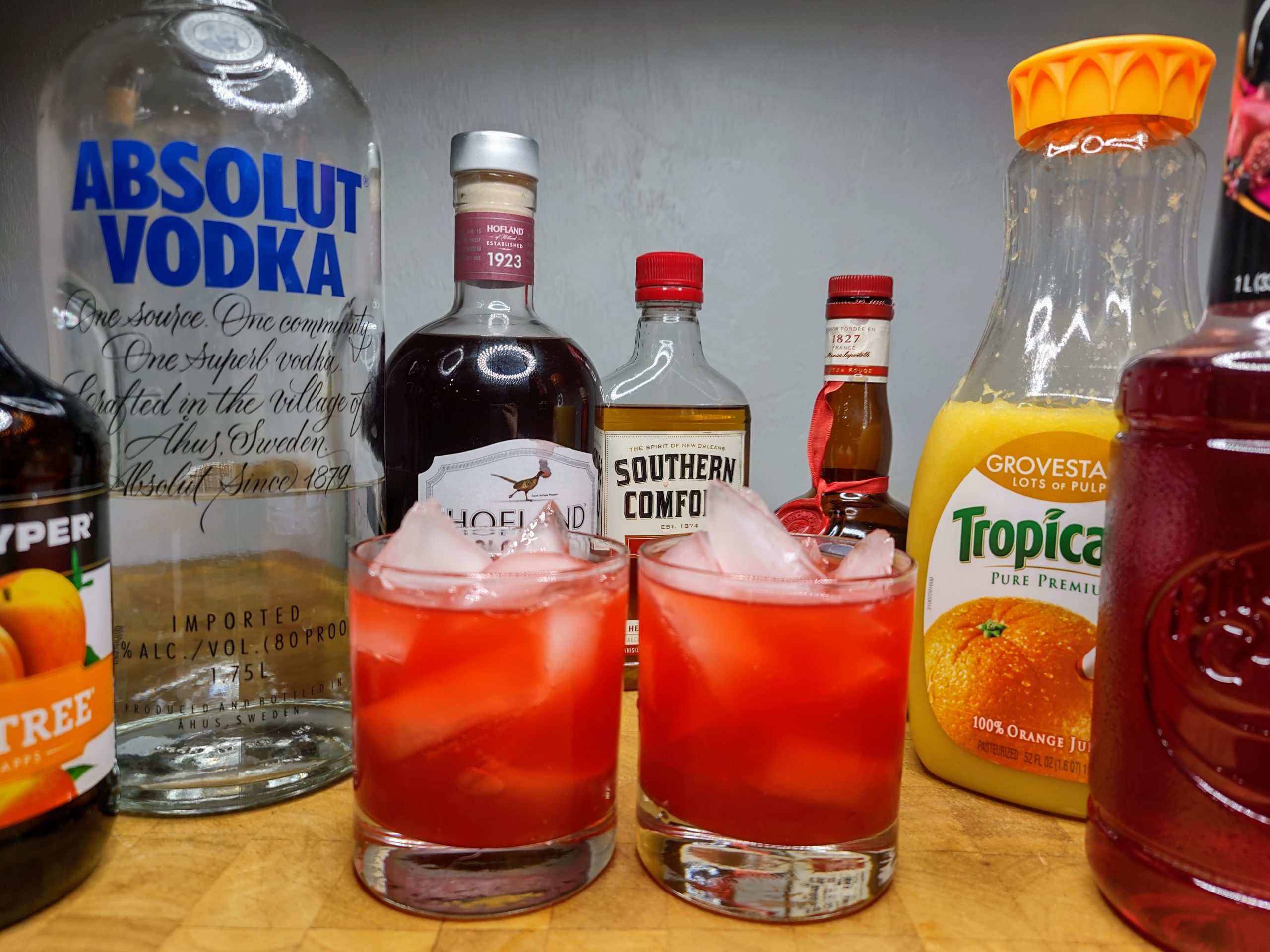 two red devil drinks surrounded by ingredients