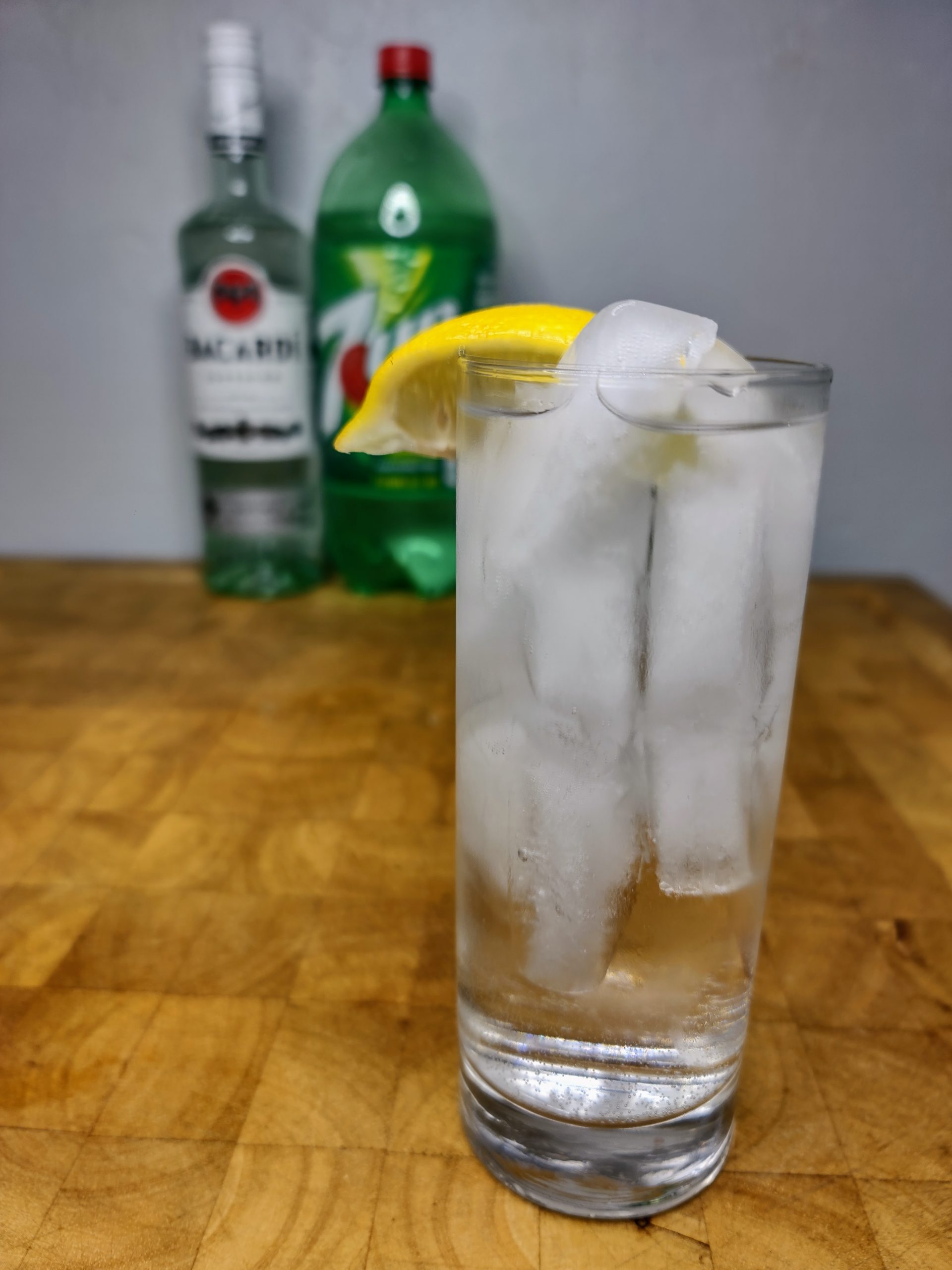 rum and 7up in a glass with ingredients in background