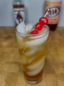 rum and cream soda in a glass with cherry garnish