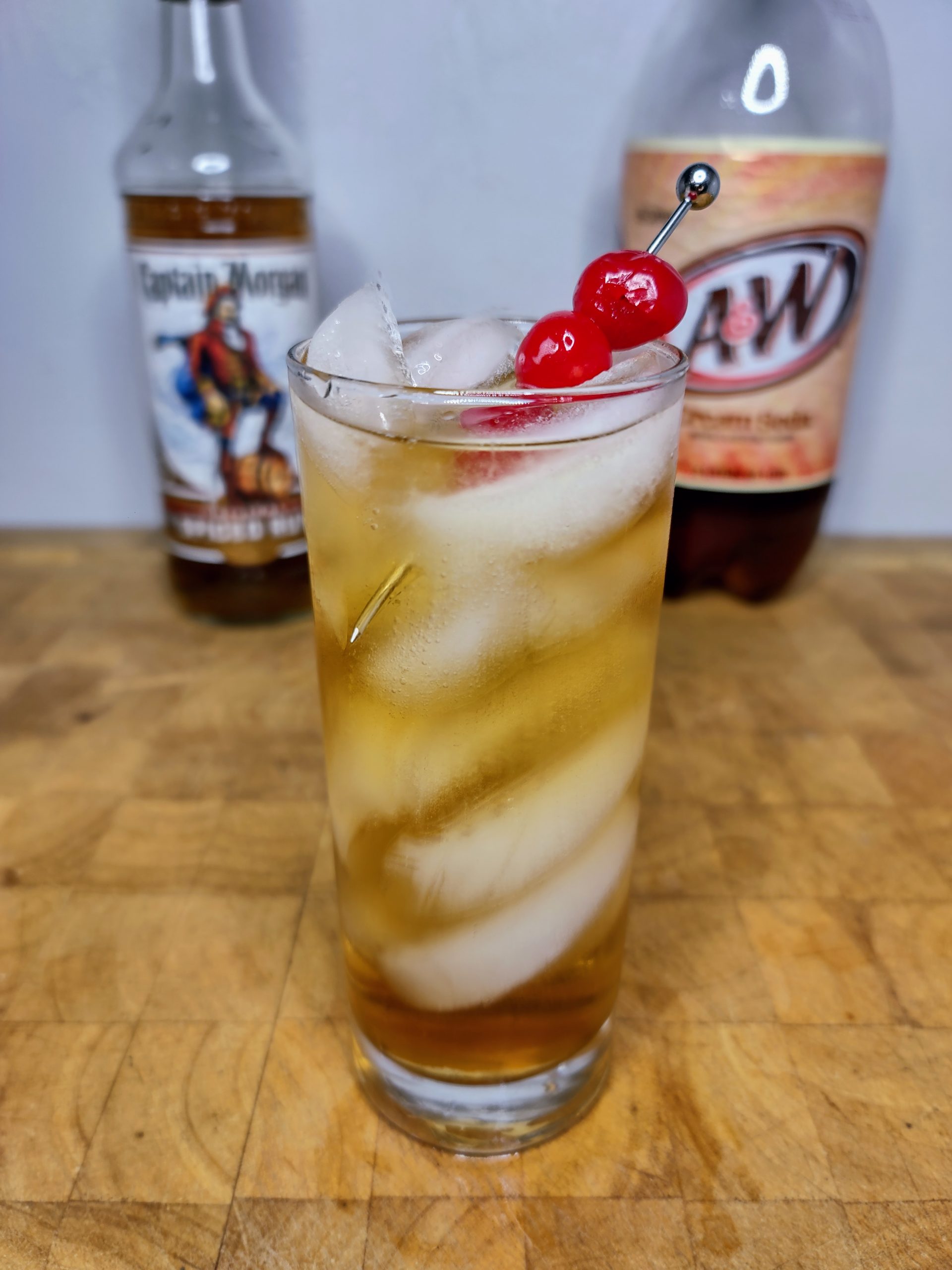 rum and cream soda cocktail with ingredients in the background