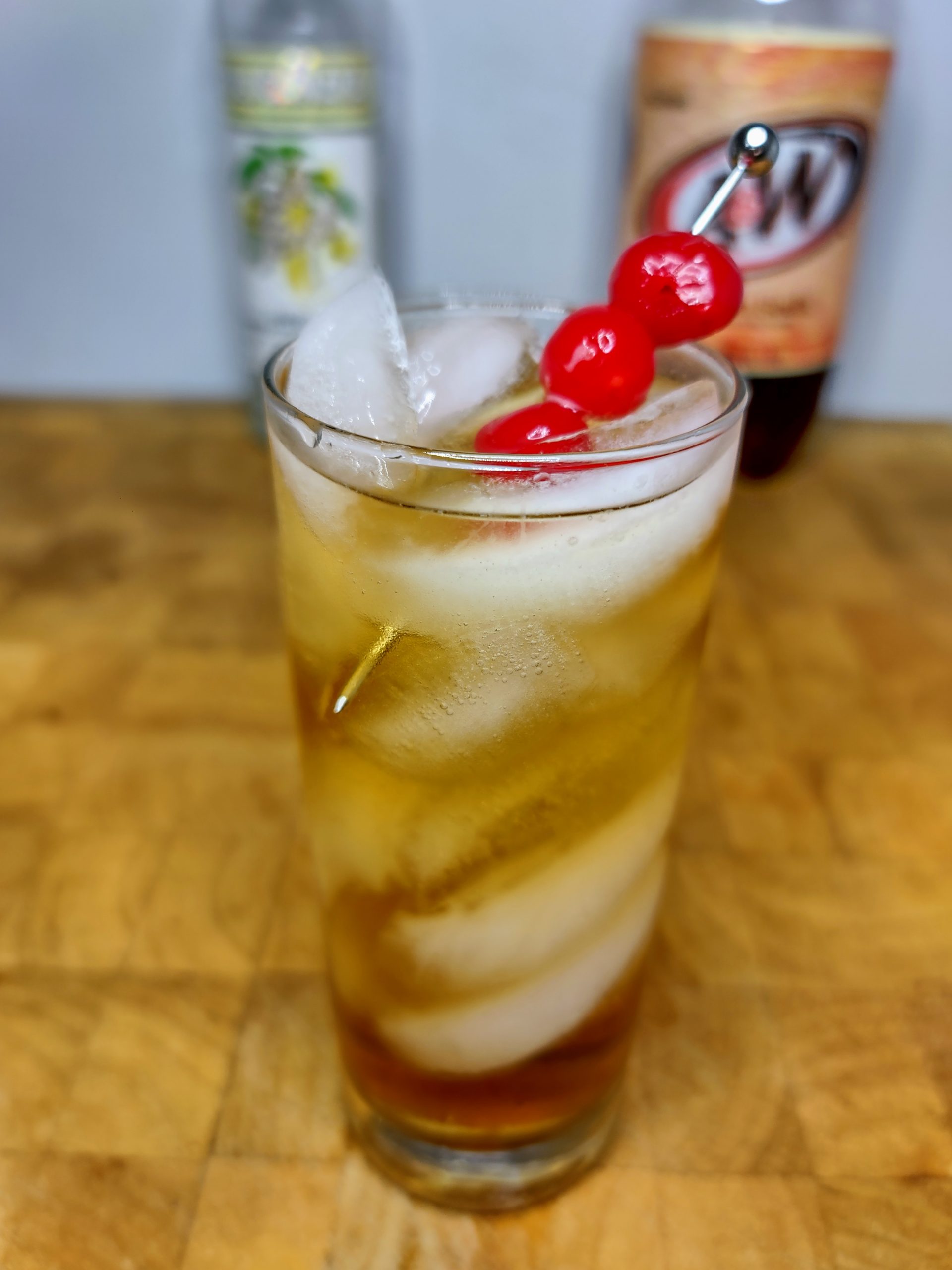 vodka and cream soda cocktail with a cherry garnish