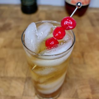 whiskey and cream soda in a glass with a cherry garnish