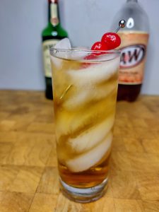 whiskey and cream soda in a glass on a wooden table