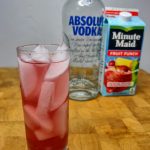 vodka and fruit punch with ingredient bottles in background