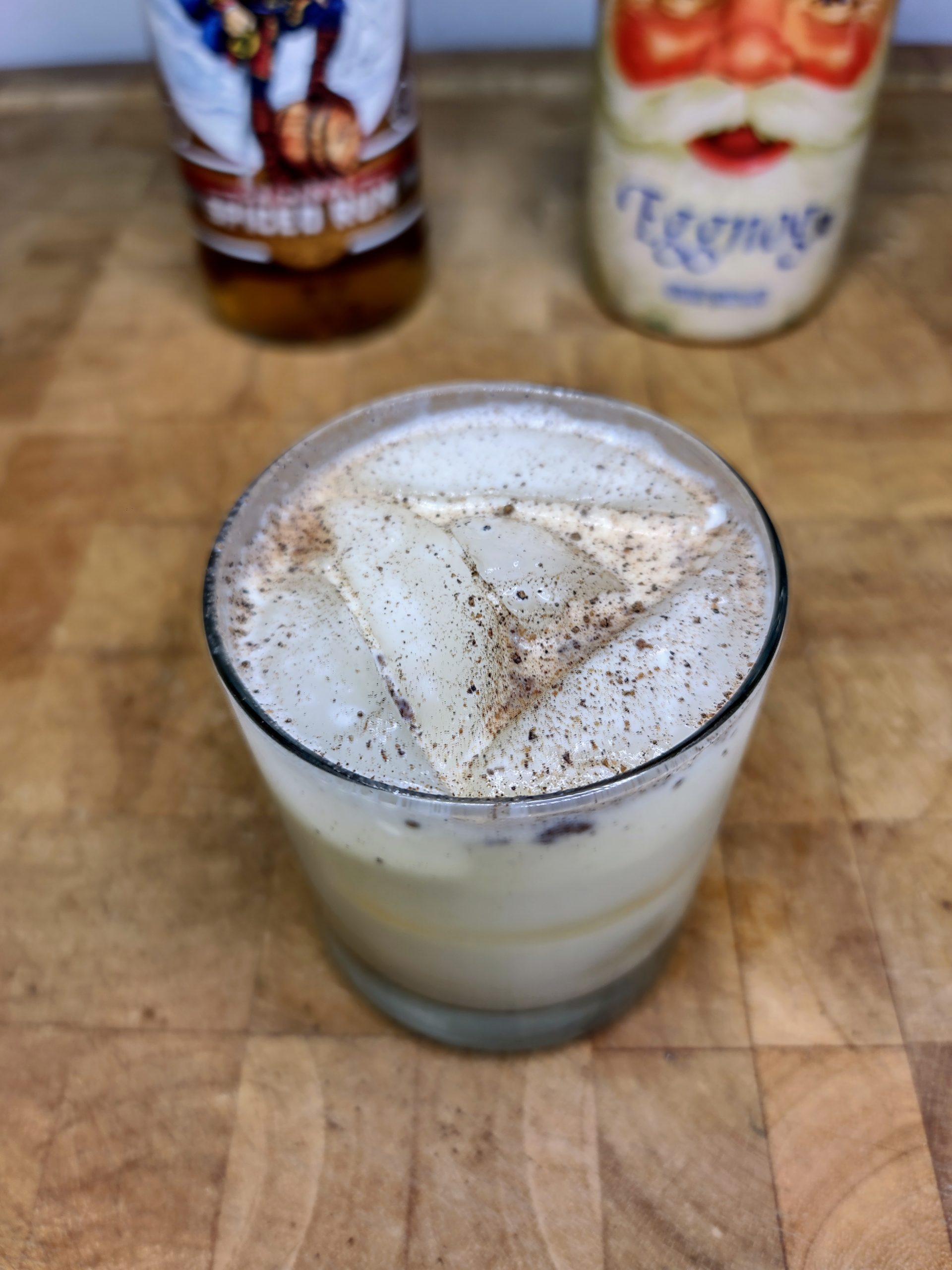 top down view of rum and eggnog on a wooden table