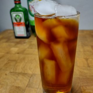 jager and gingerale on a wooden table with ingredients in background