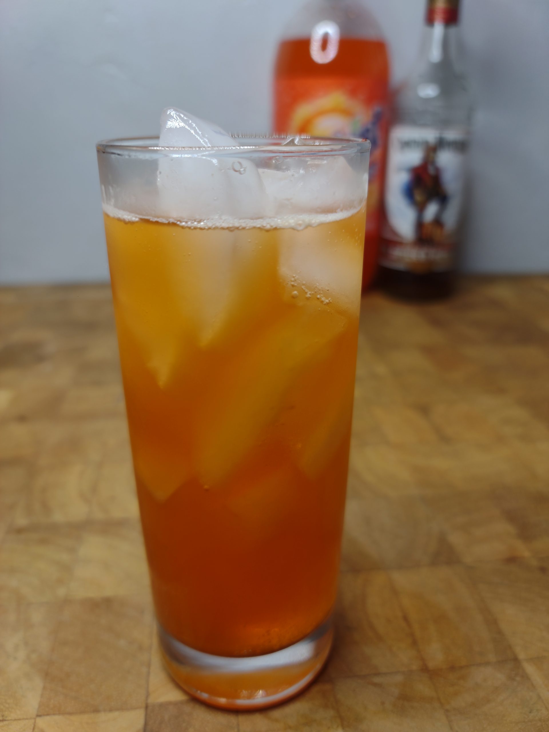 rum and orange soda in a highball with ingredients in the background