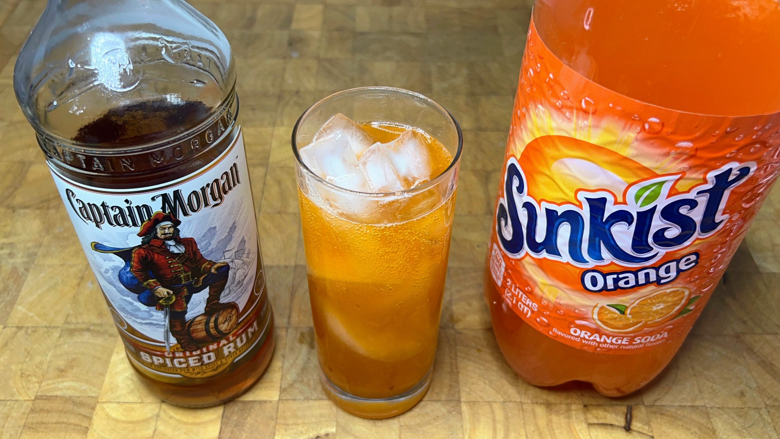 top down view of orange soda and vodka cocktail with ingredients next to the glass