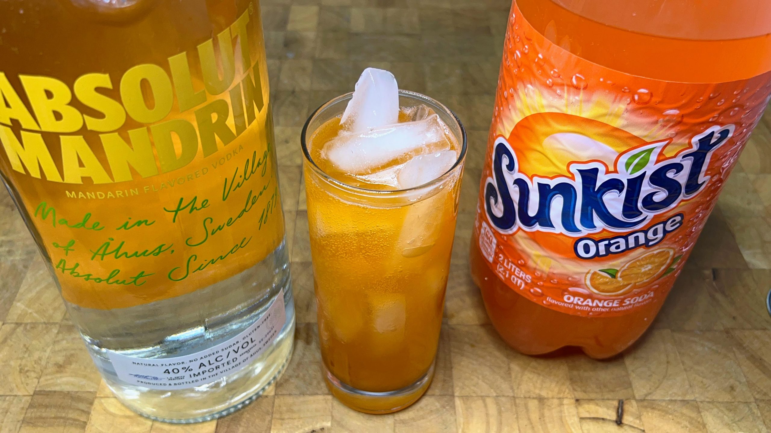vodka and orange soda with ingredients next to the drink