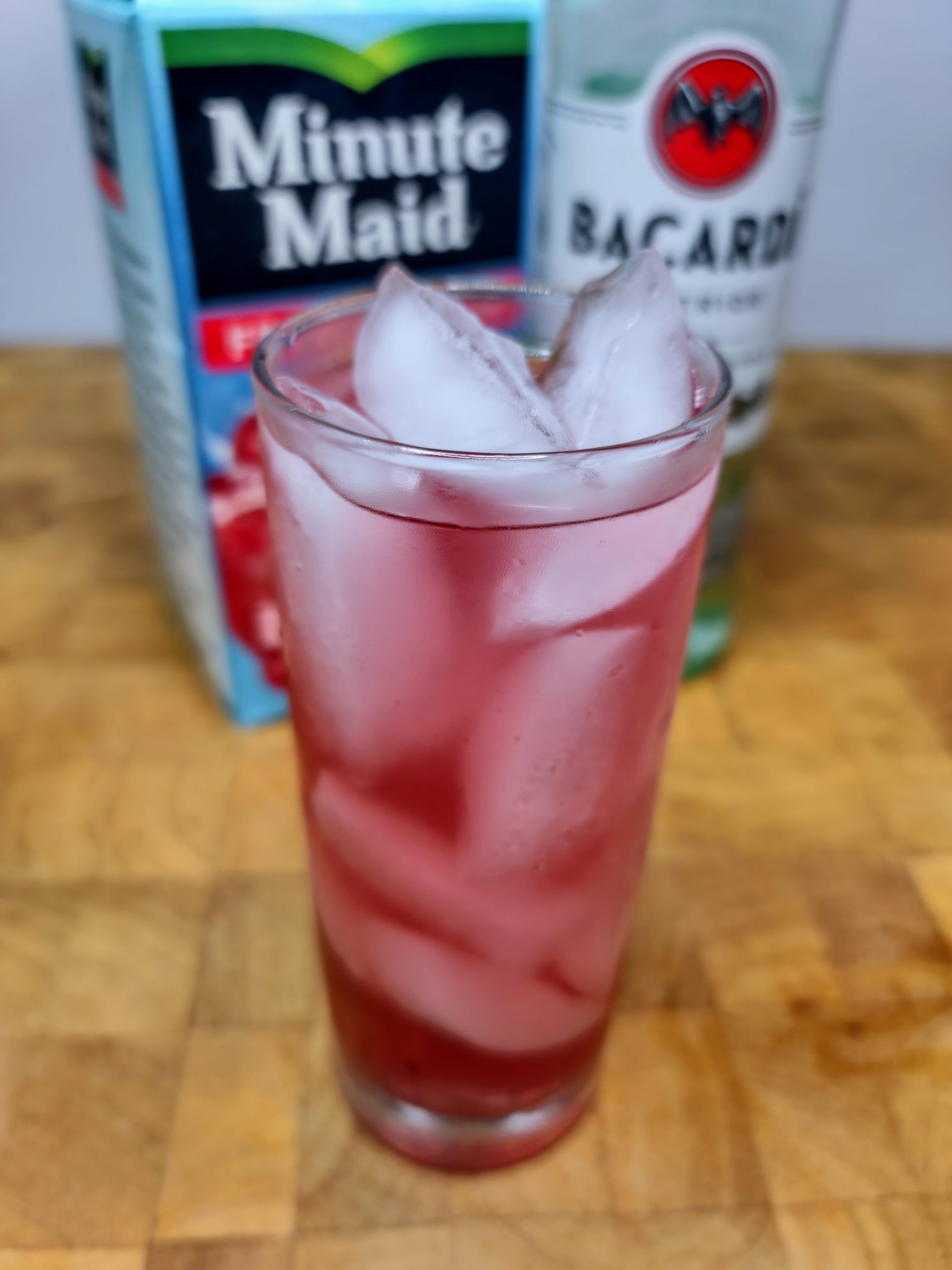 rum and fruit punch with ingredient bottles in background