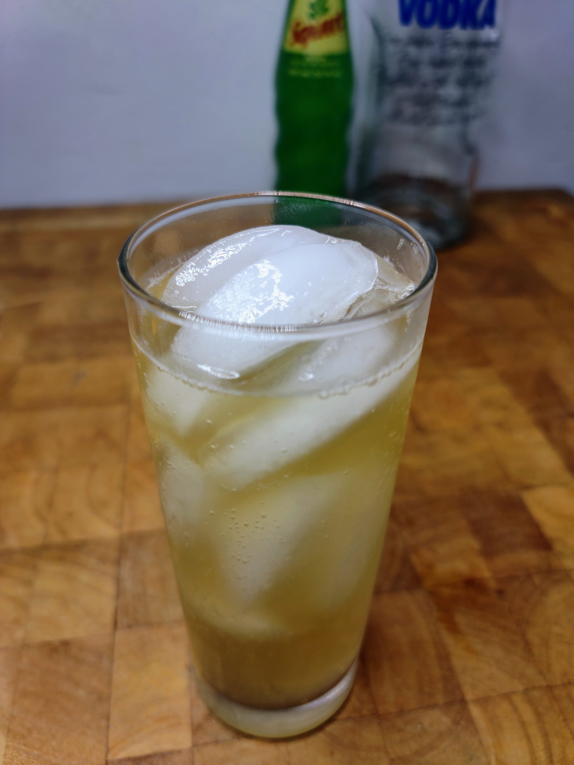 vodka and squirt soda in a highball glass with ingredients behind the dirnk 