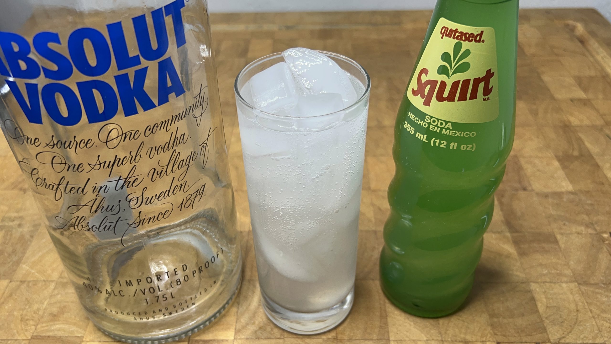 vodka and squirt with ingredients next to the glass
