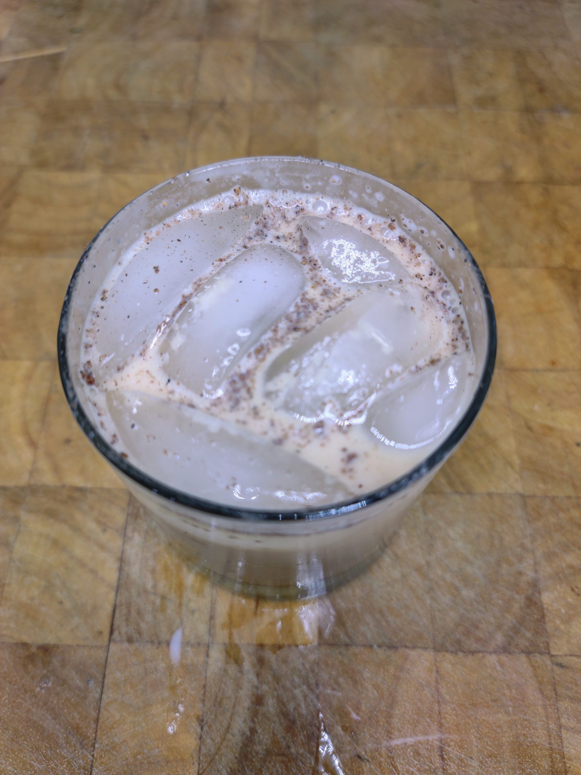 top down view of toasted almond cocktail on a wooden table