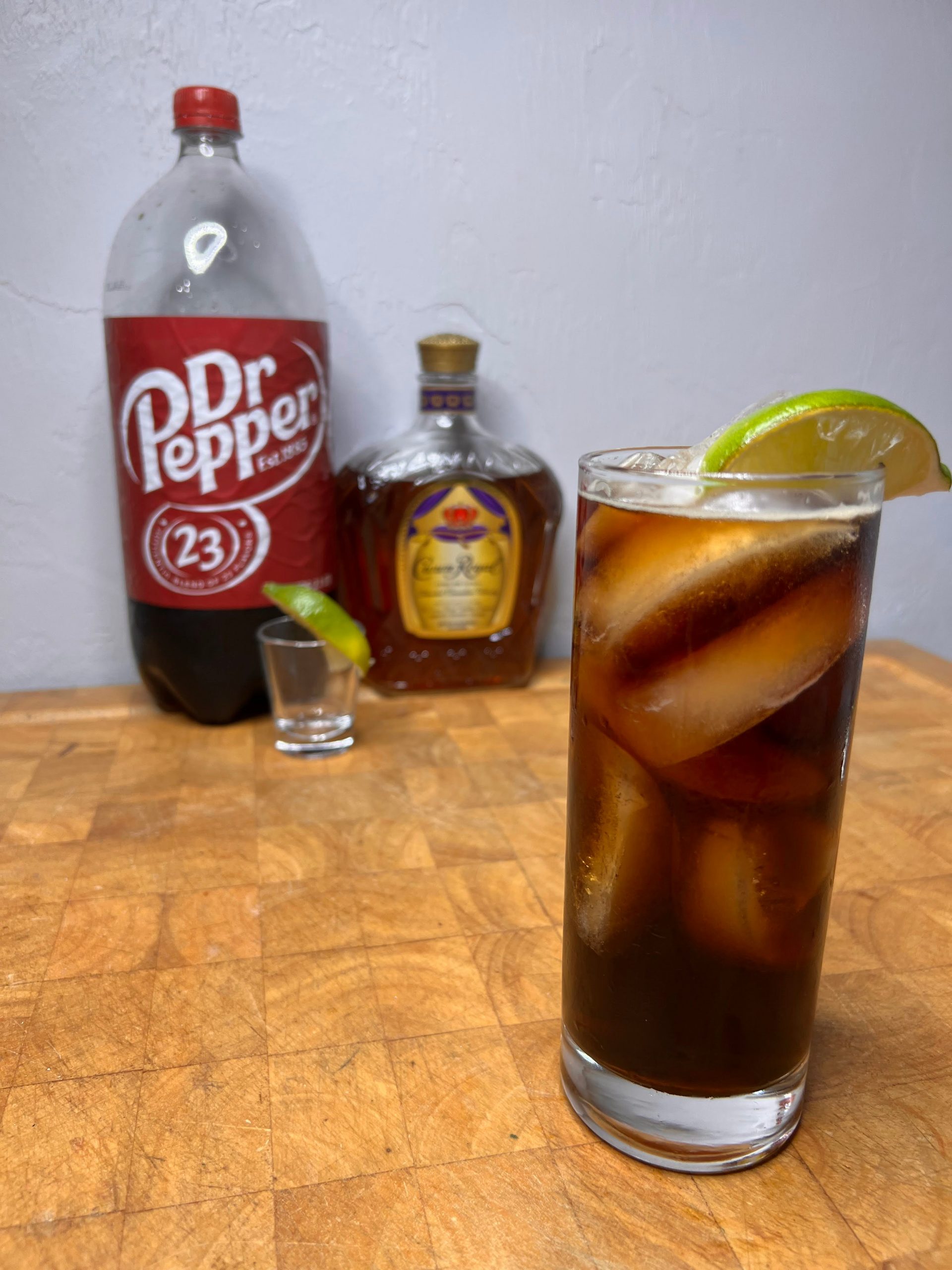 dr pepper cocktail with crown royal on a wooden table