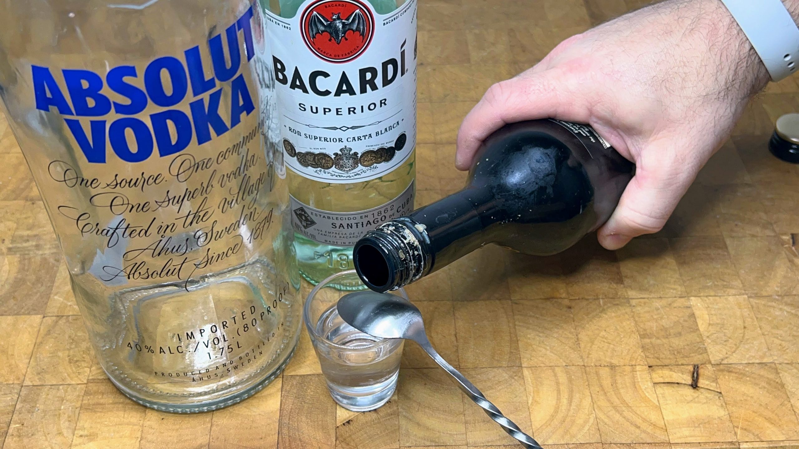 pouring irish cream over the back of a bar spoon