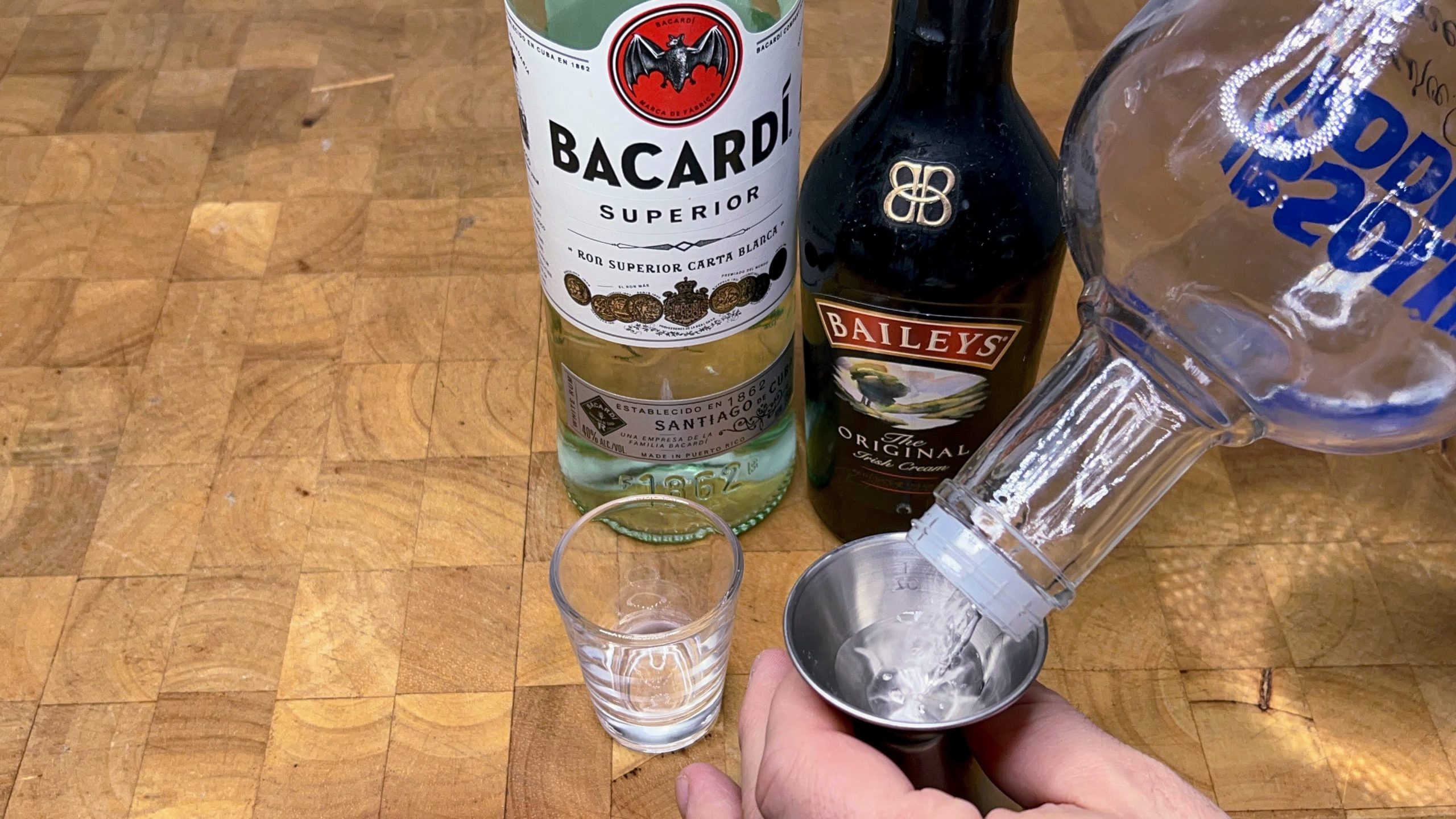 pouring vodka into a jigger
