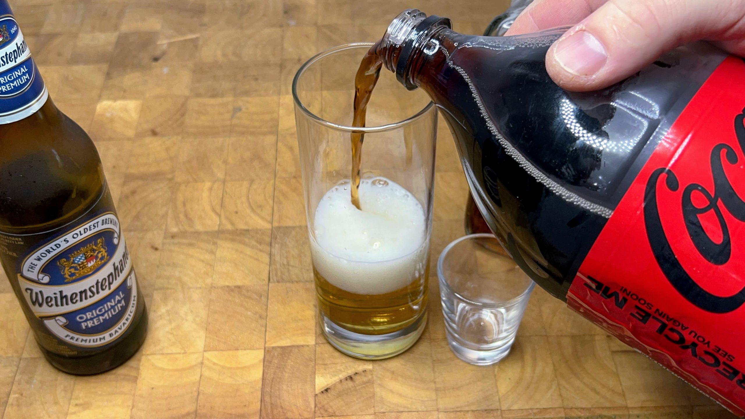 pouring coke into a highball glass