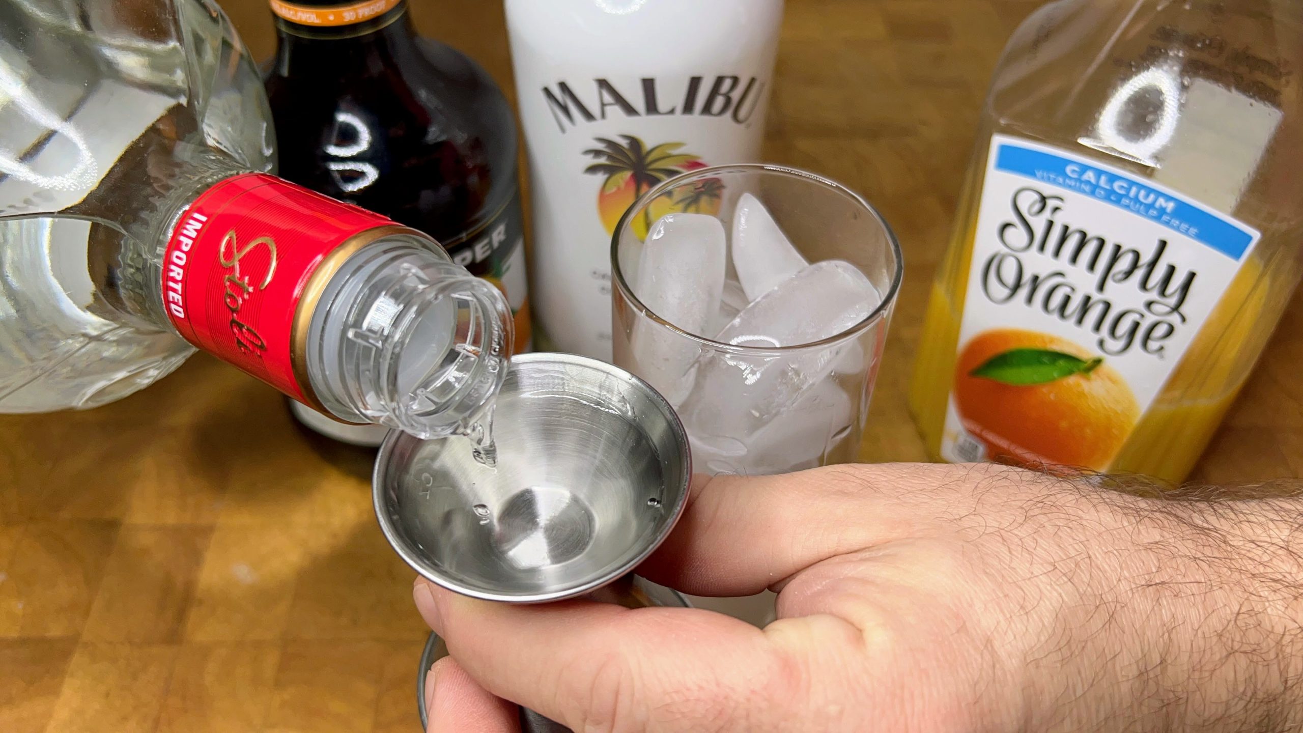 Measuring vodka with a jigger