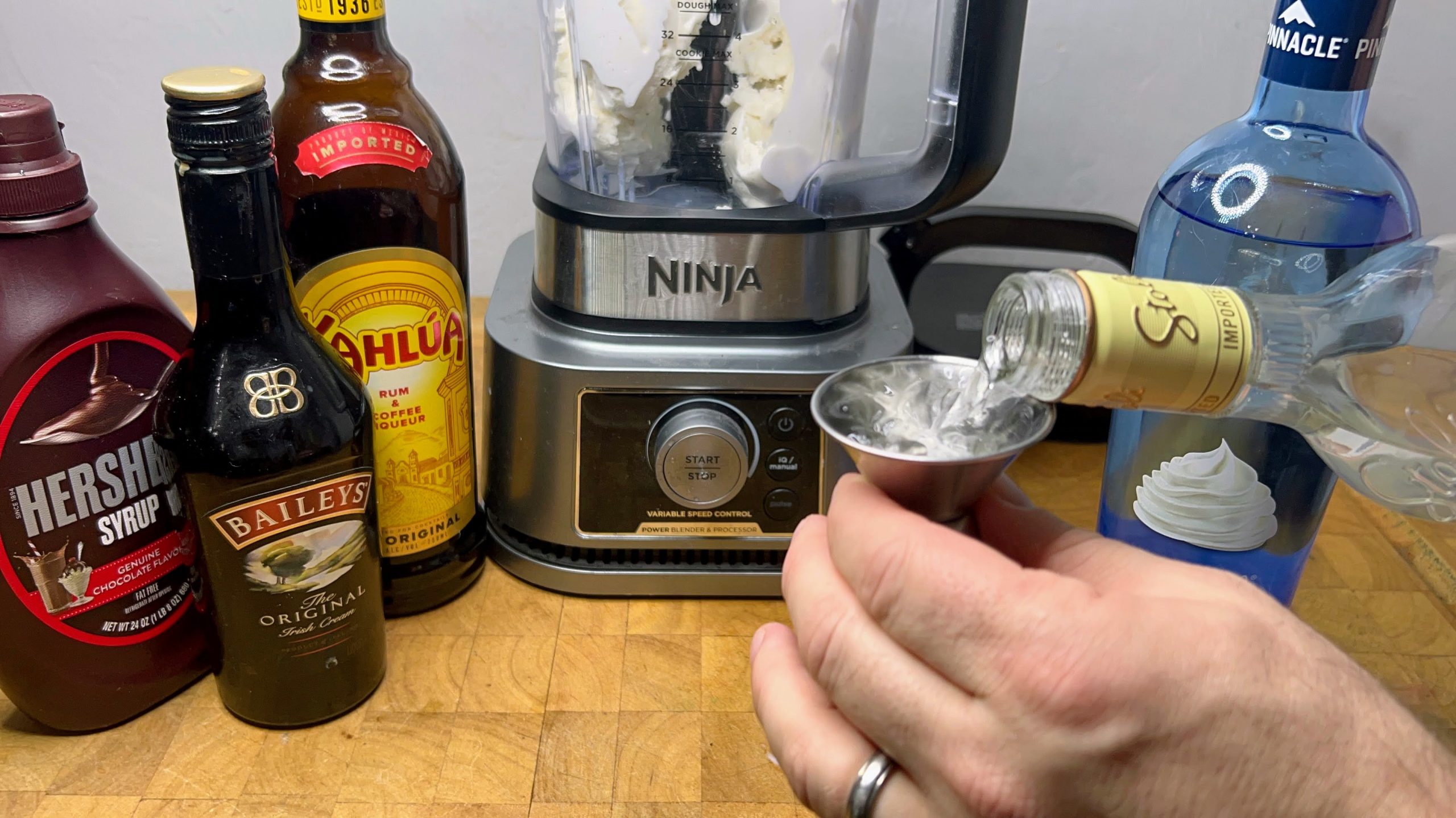 pouring vanilla vodka into a jigger