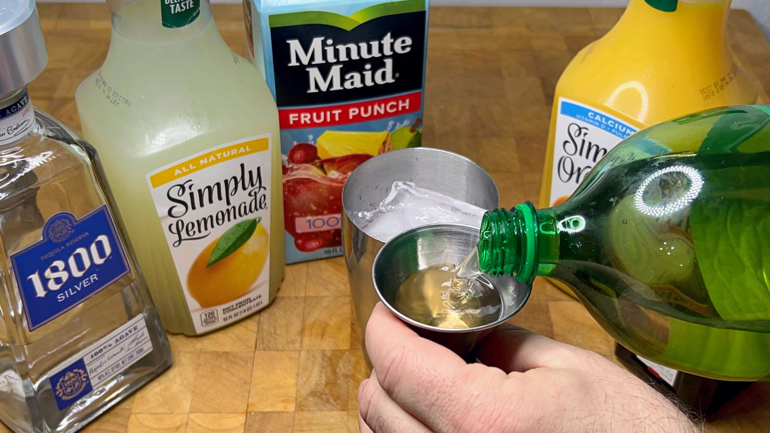 pouring gingerale into a jigger