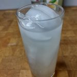 raspberry vodka lemonade in a highball glass on a wooden table