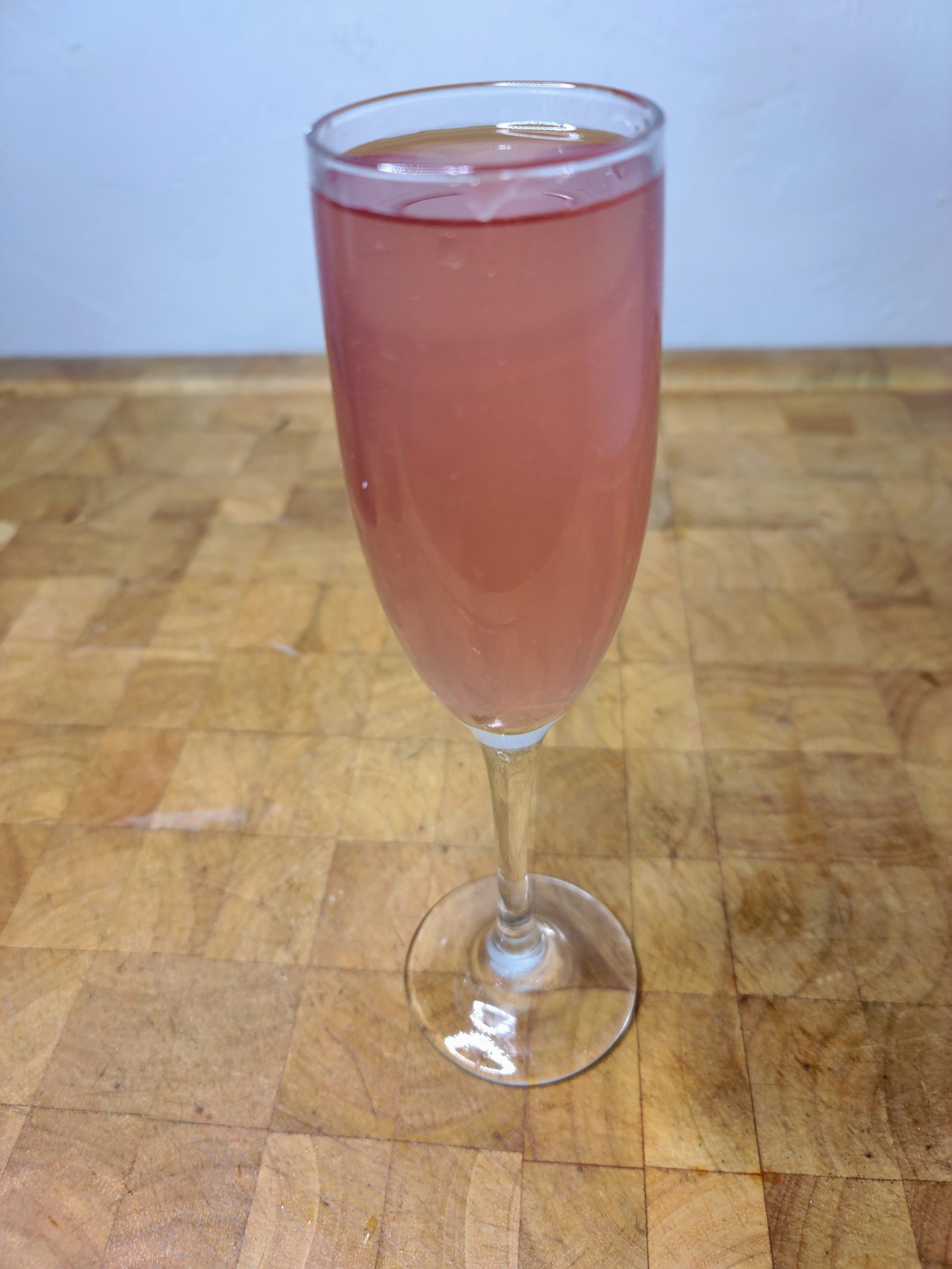closeup of thug passion drink in a champagne flute on a wooden table