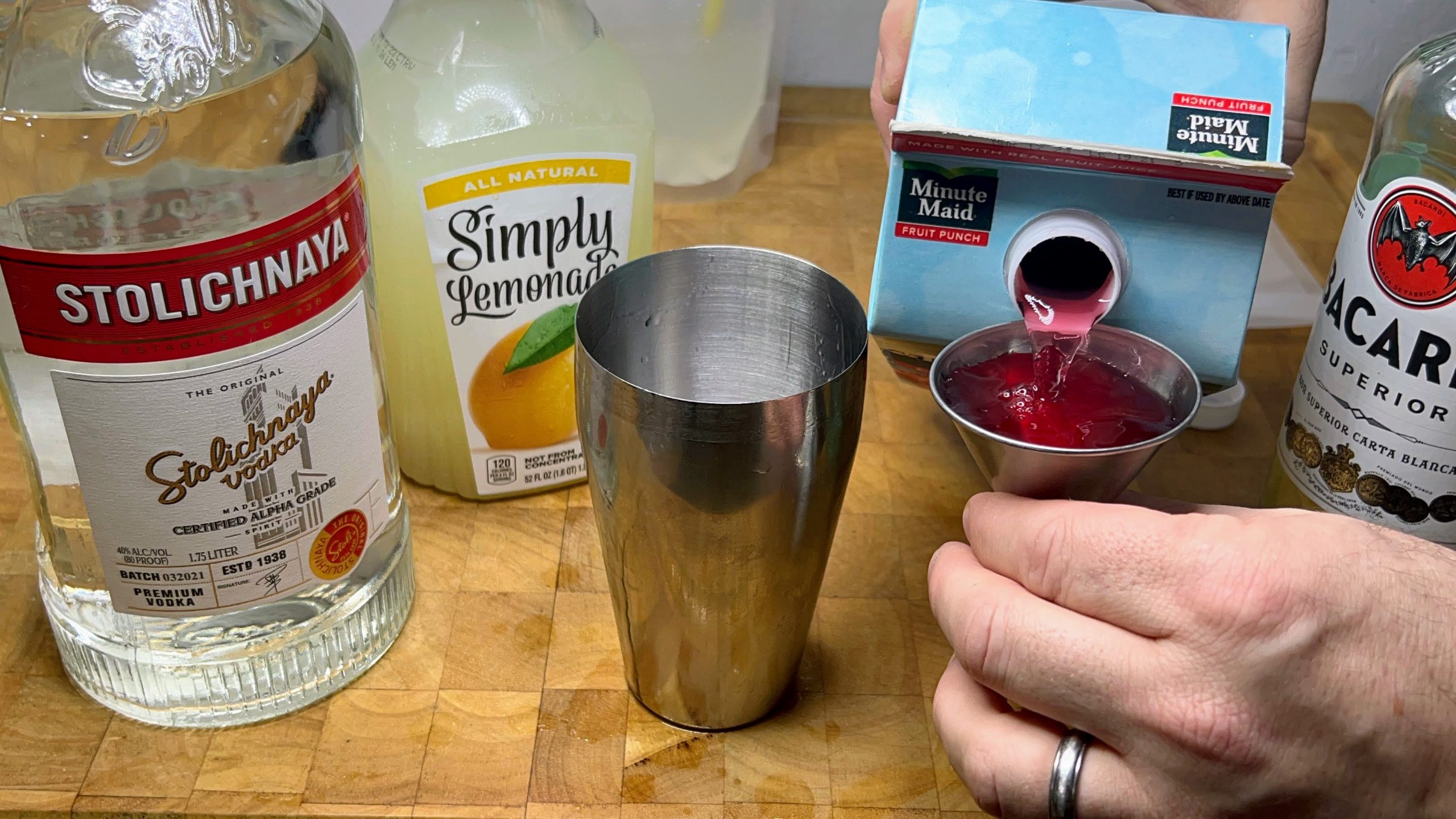 pouring fruit punch in a jigger
