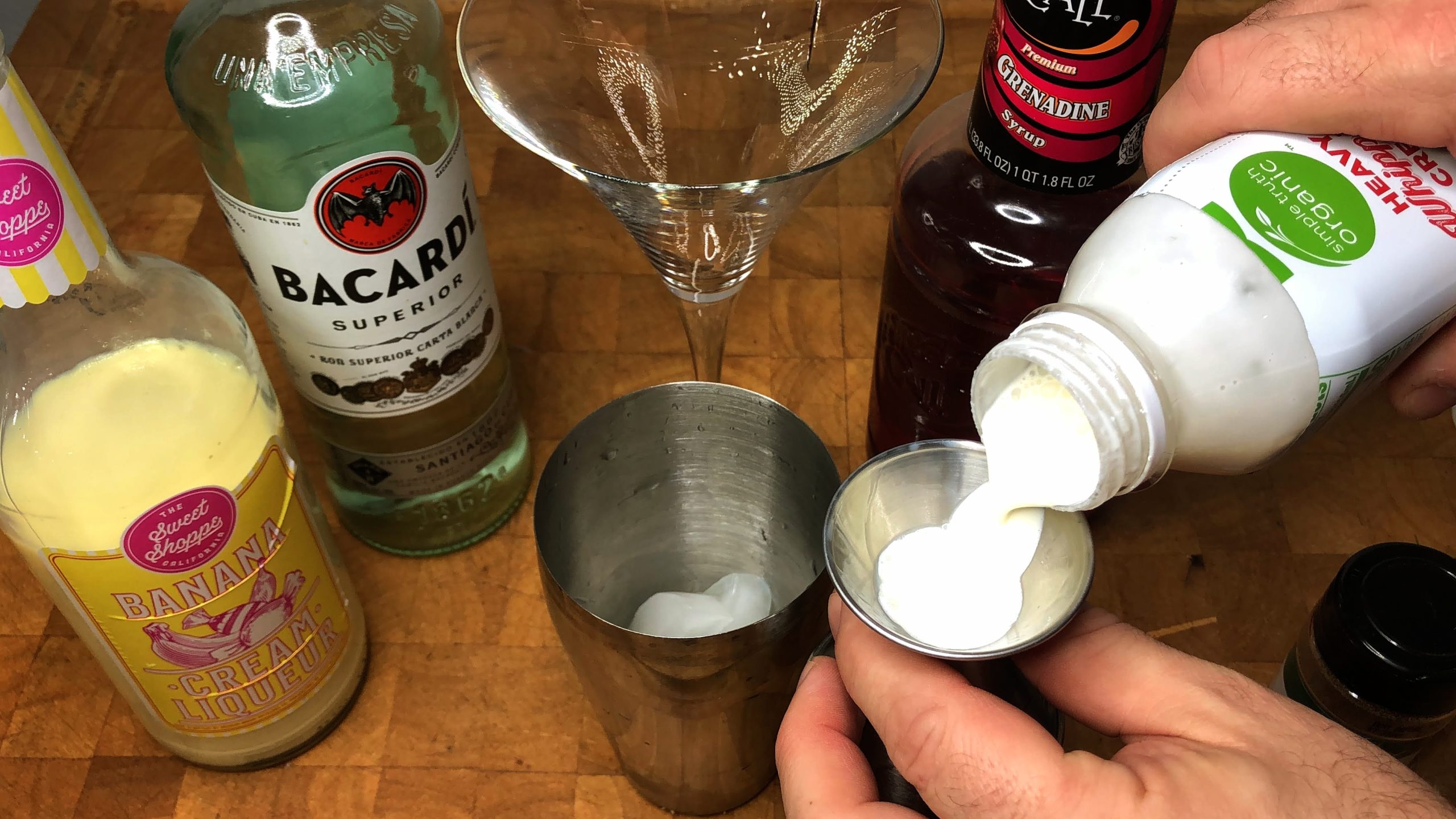 measuring heavy cream with a jigger