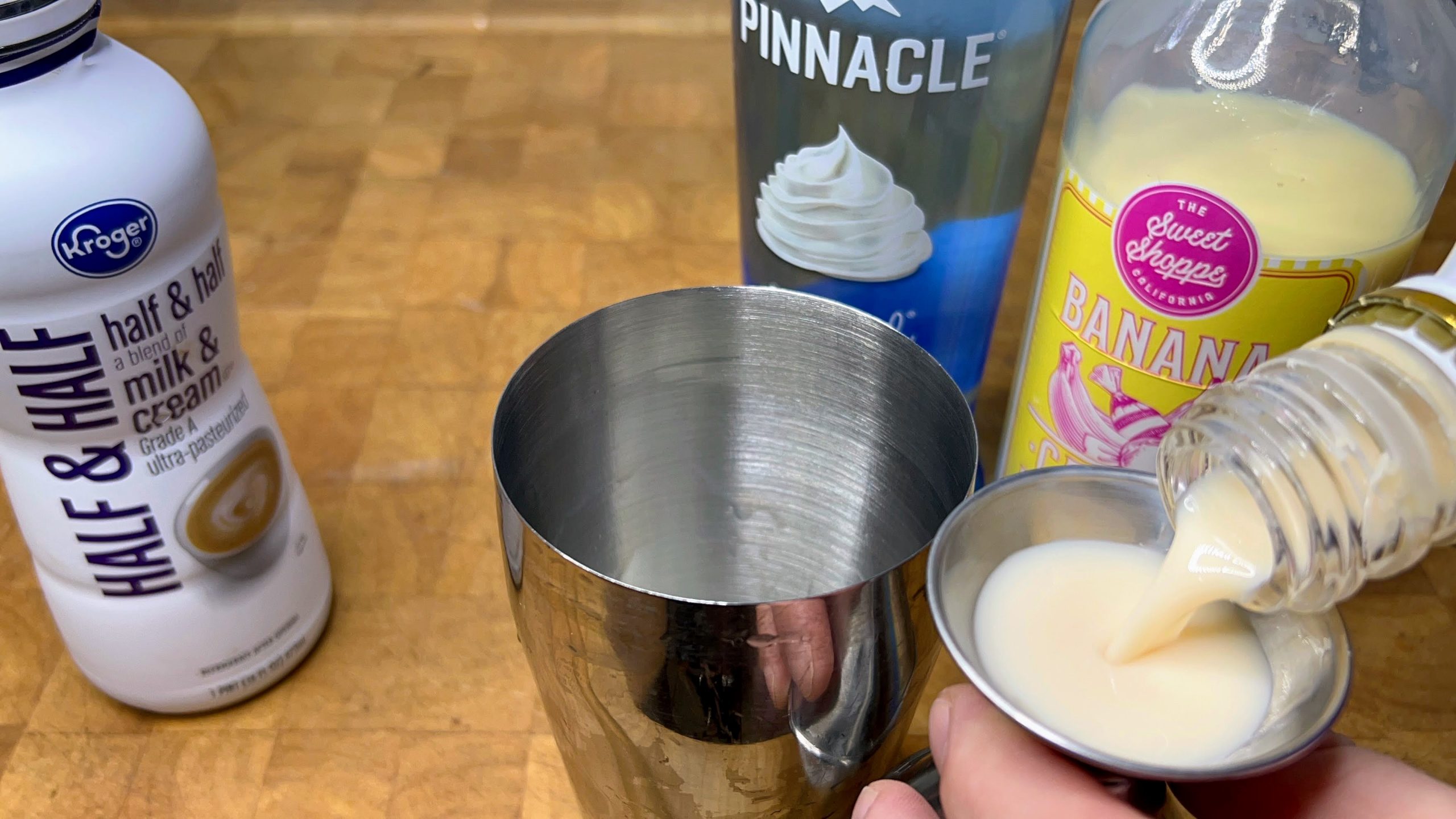 pouring rumchata into a jigger