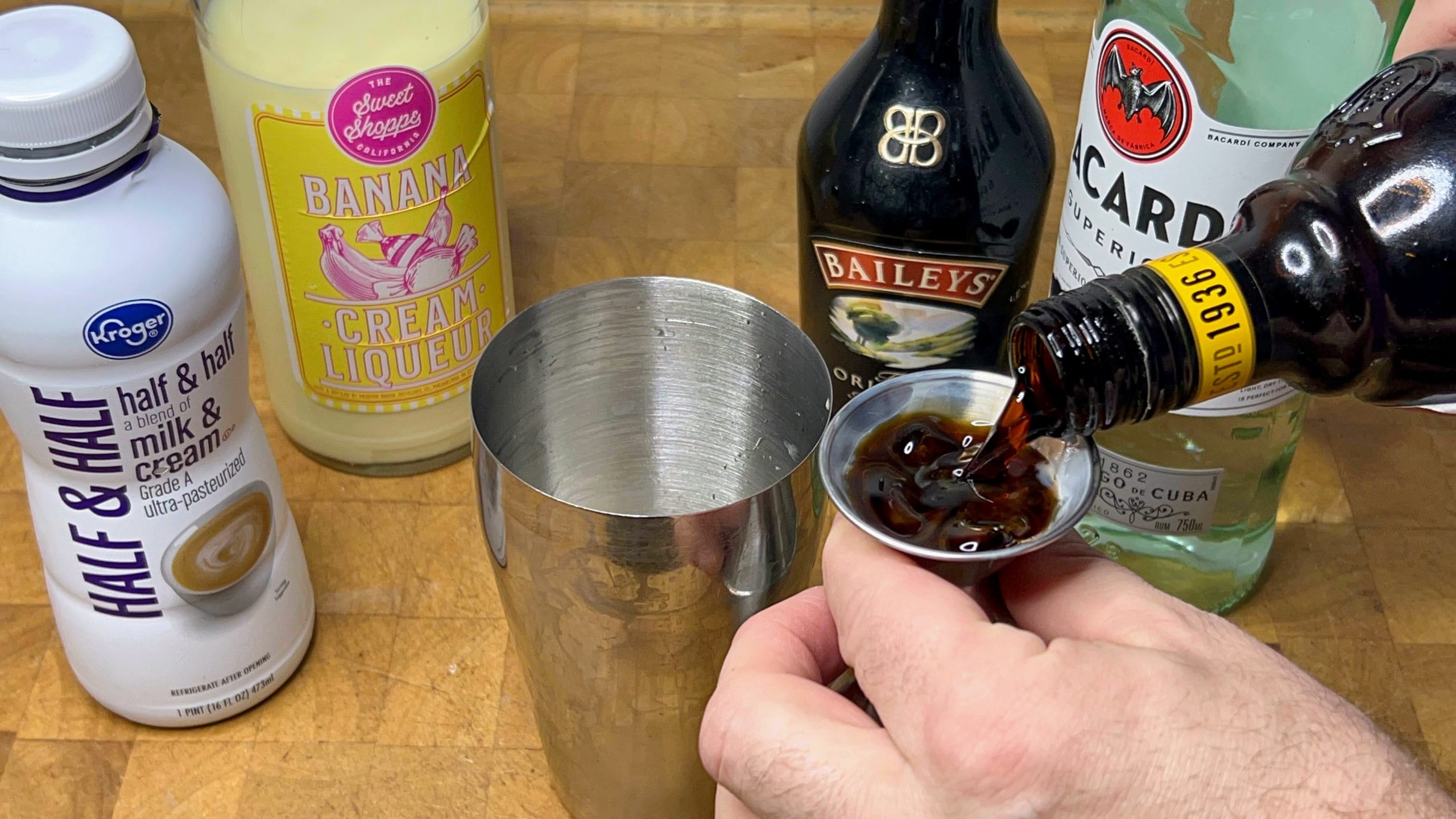 pouring kahlua out into a jigger