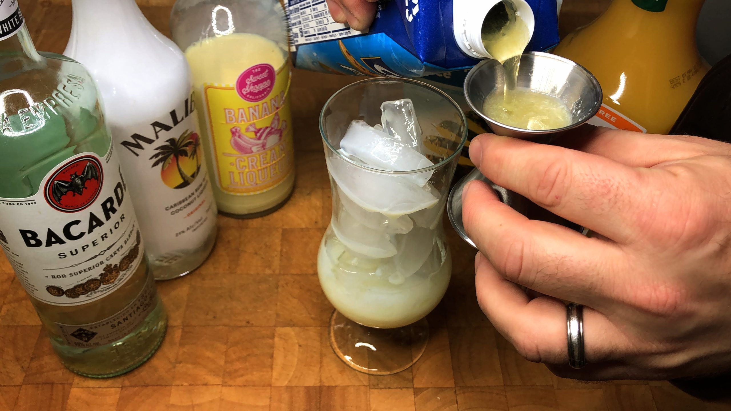 measuring passionfruit juice with a jigger