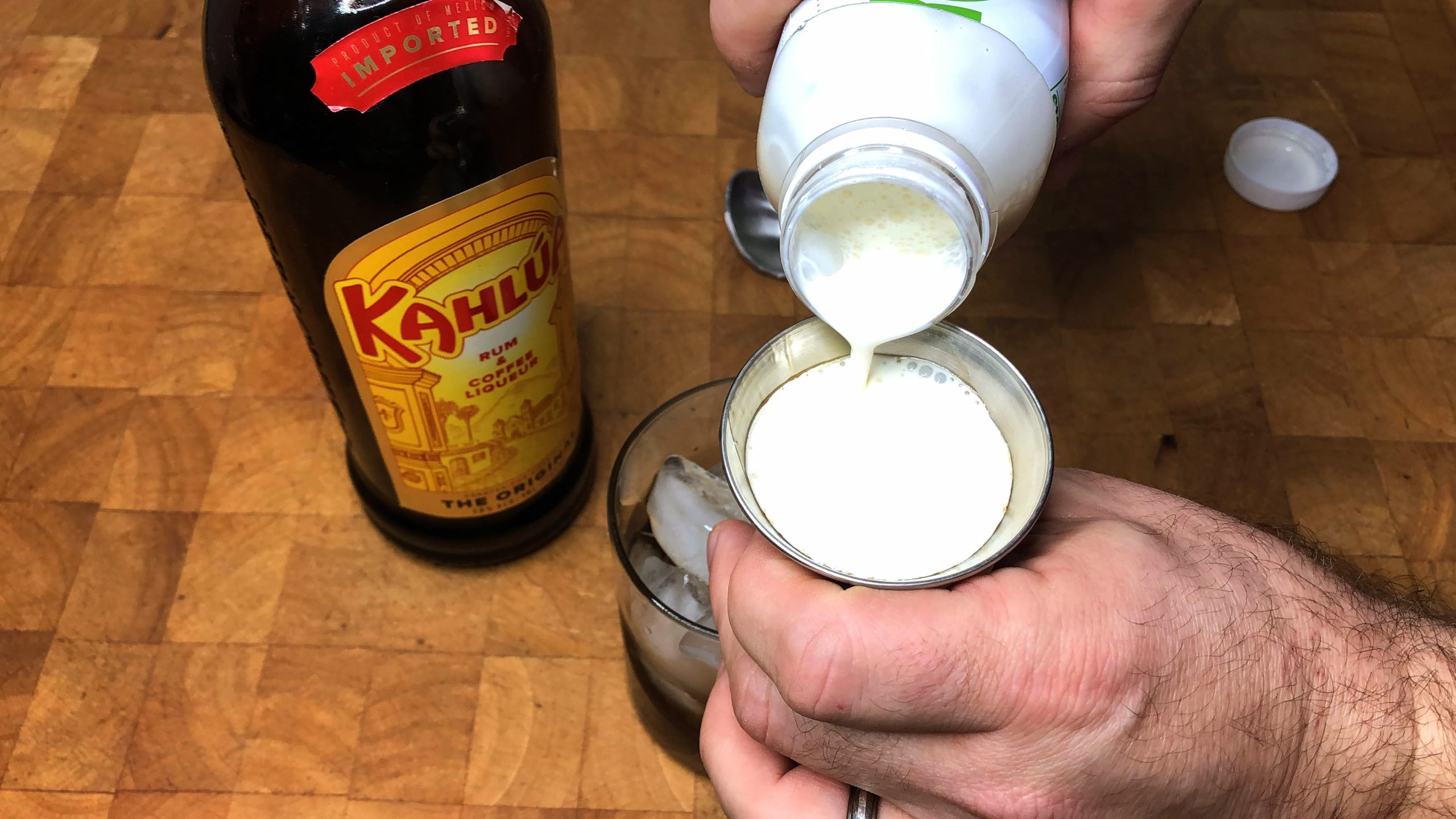 pouring heavy cream into a jigger