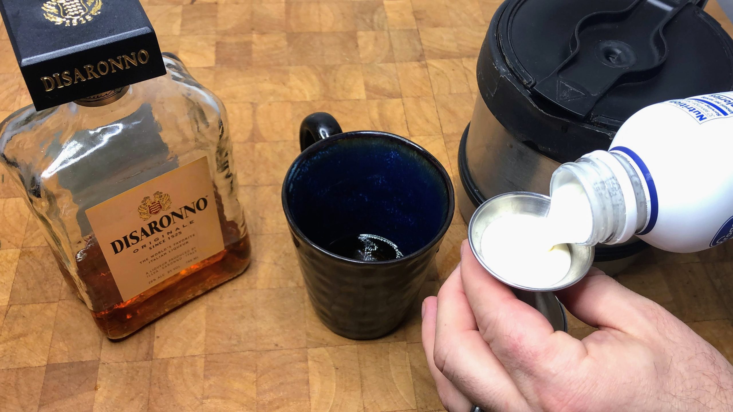 measuring out heavy cream with a jigger