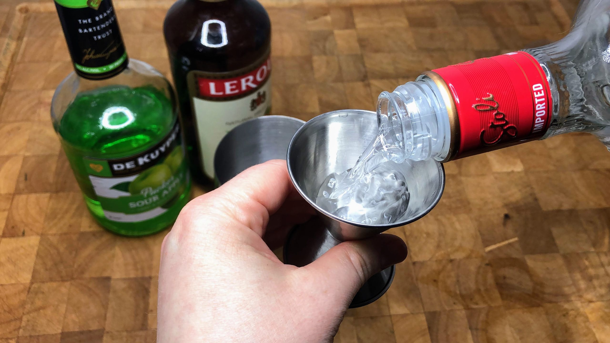 using jigger to measure vodka