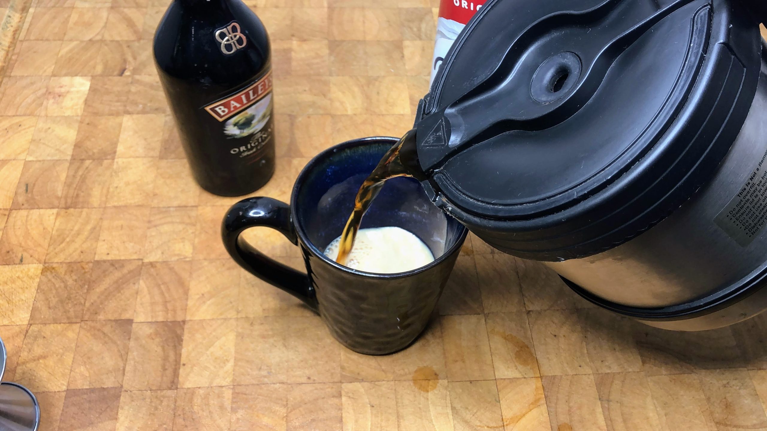 pouring hot coffee into a coffee mug