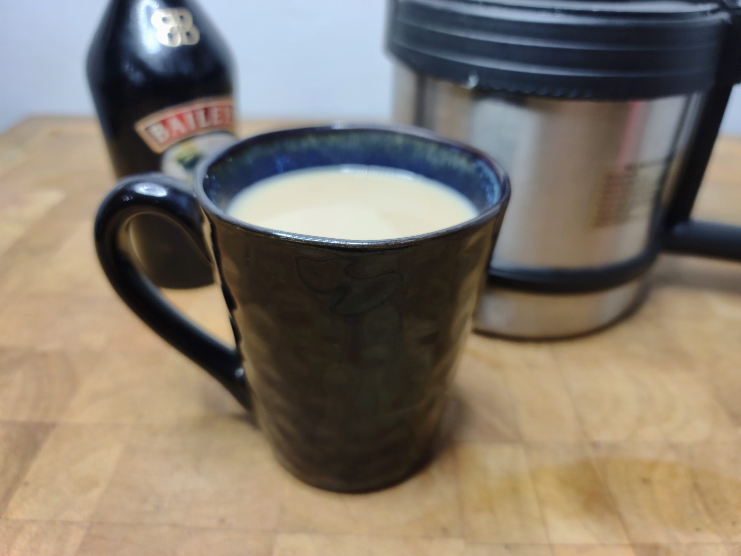 bailey's coffee in a mug with ingredients in the background