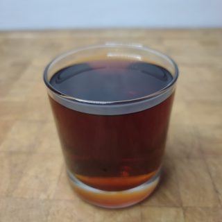 brandy coffee in a rocks glass on a wooden table