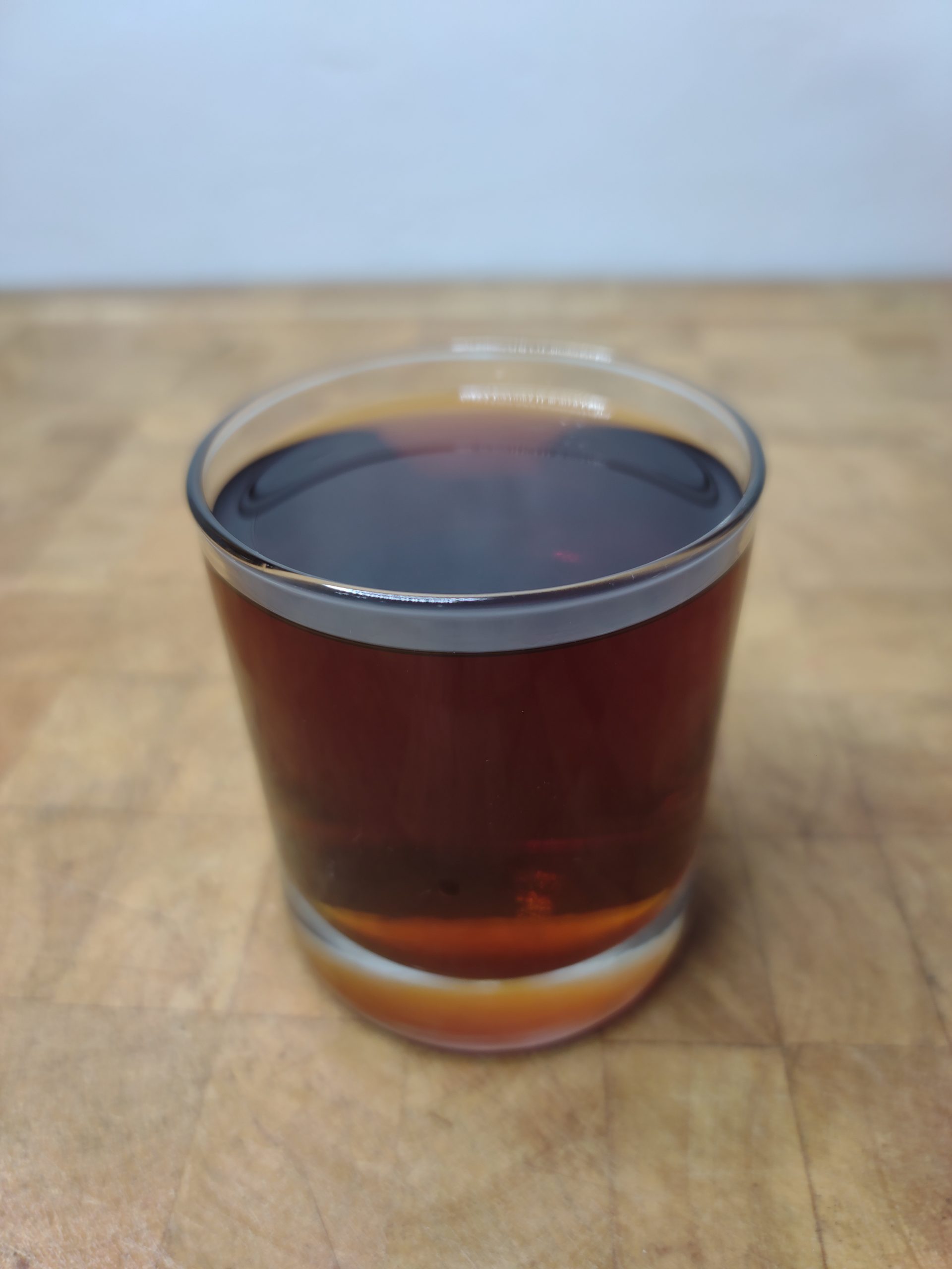 brandy coffee in a rocks glass on a wooden table
