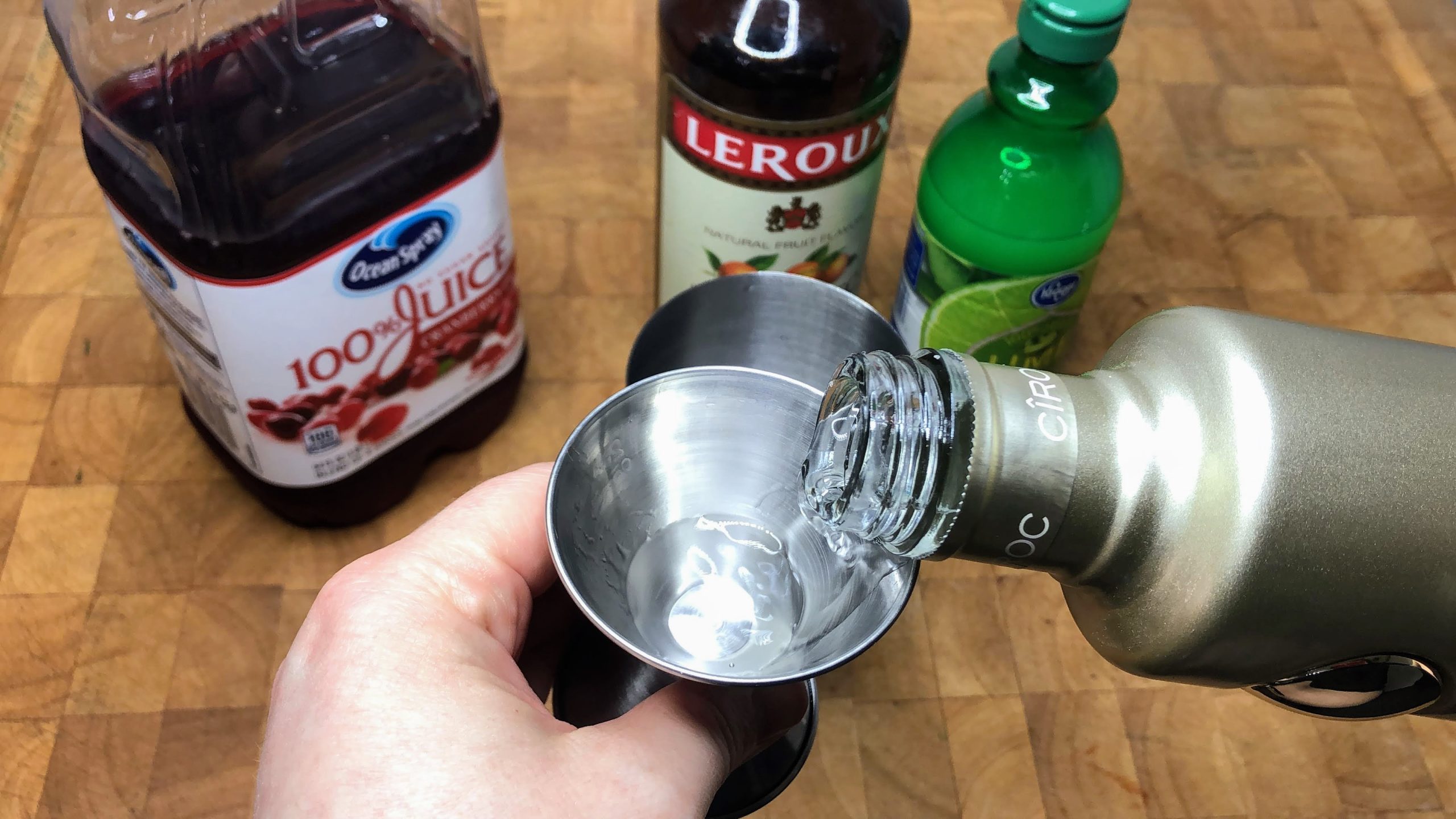 pouring grape vodka in a jigger