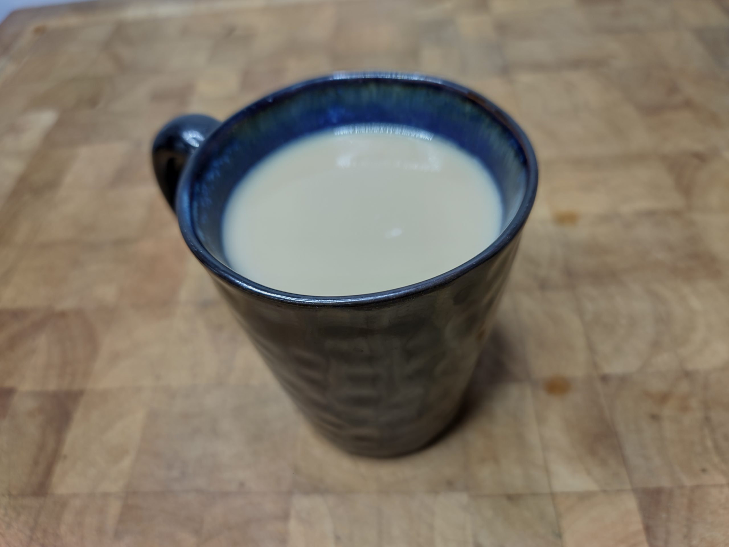closeup of rumchata coffee in a mug on a wooden table